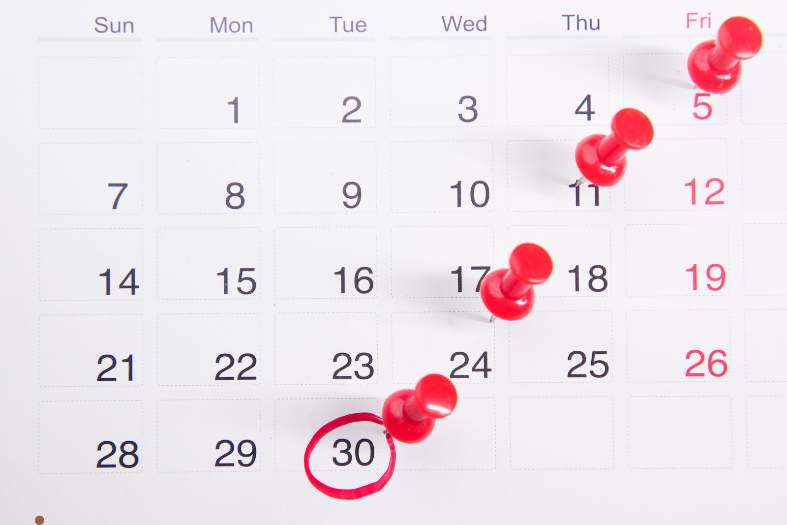 Calendar and clock on a clean desk suggesting scheduled appointments