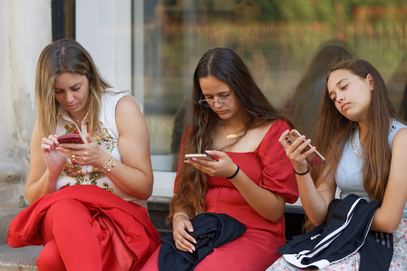 Professional woman checking messages on phone in urban setting