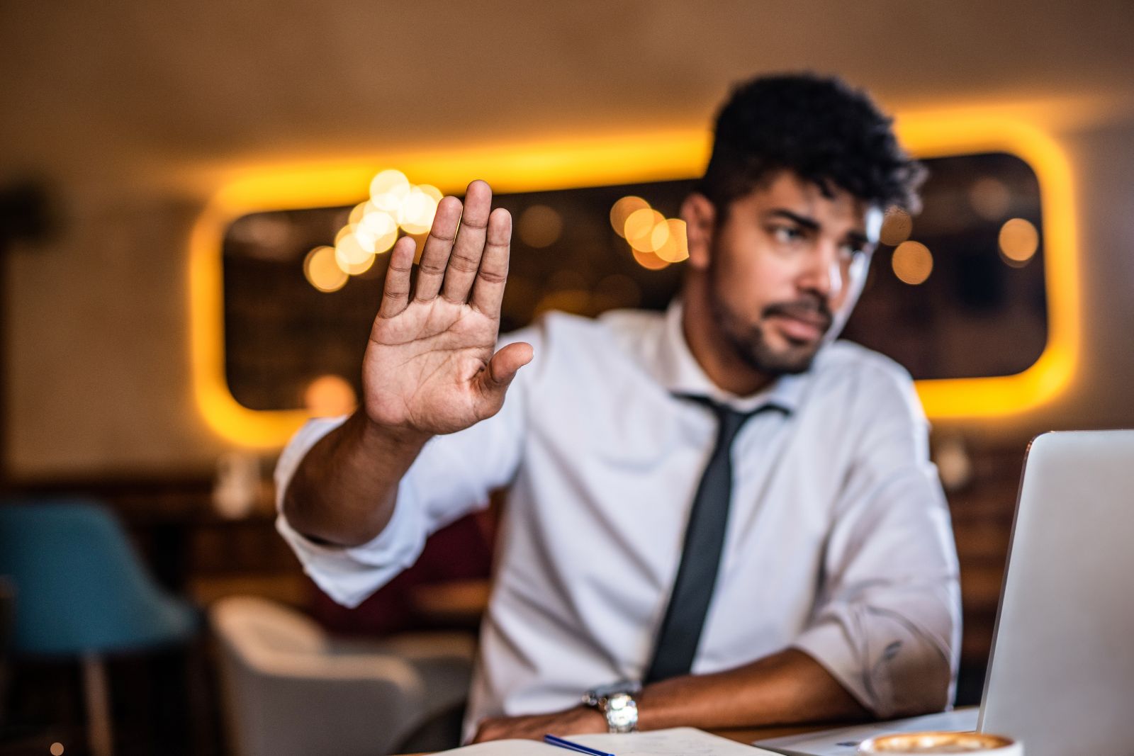 Person looking at phone screen with unanswered messages in dim lighting