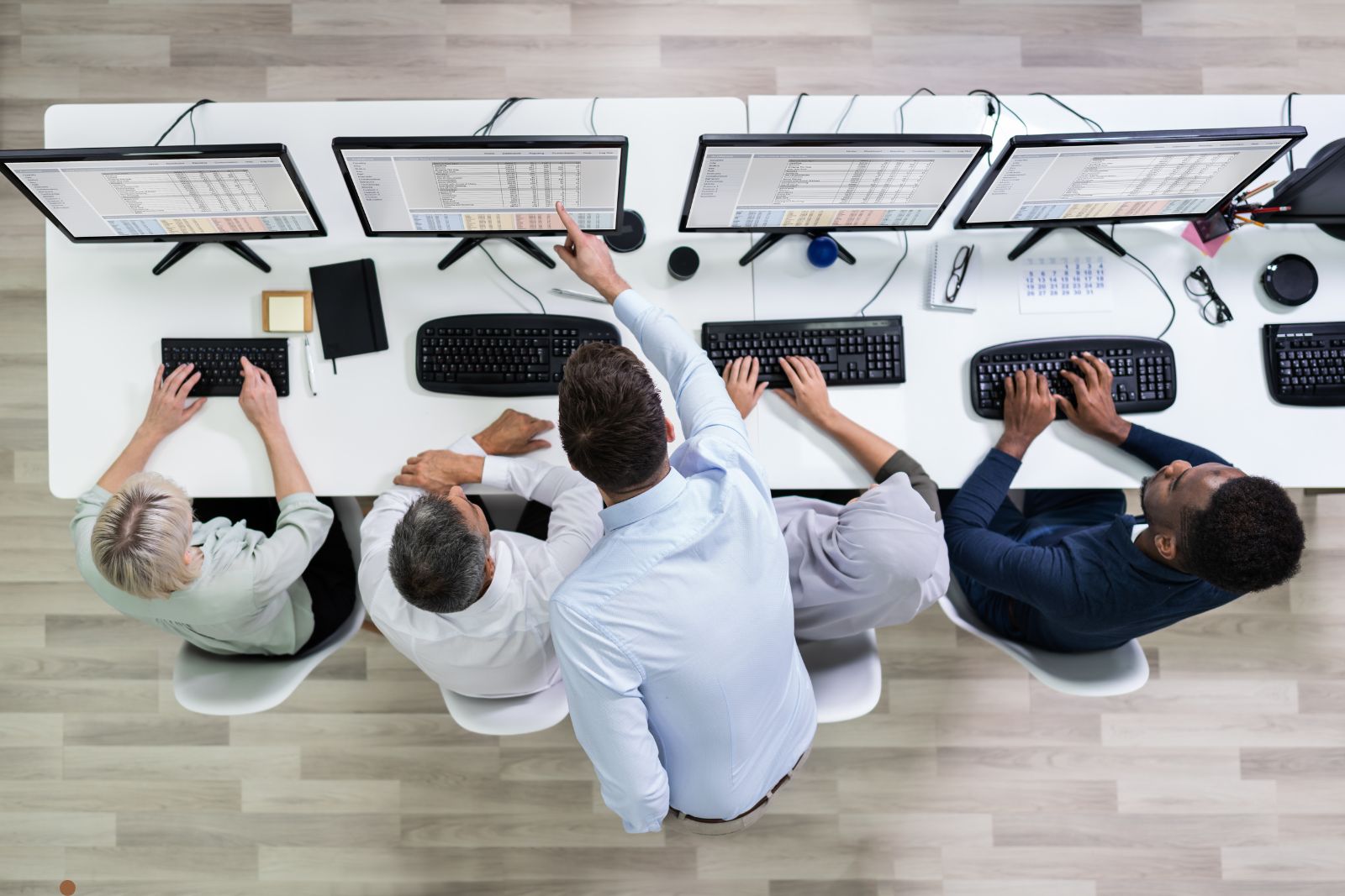 Sales team working at desks making phone calls